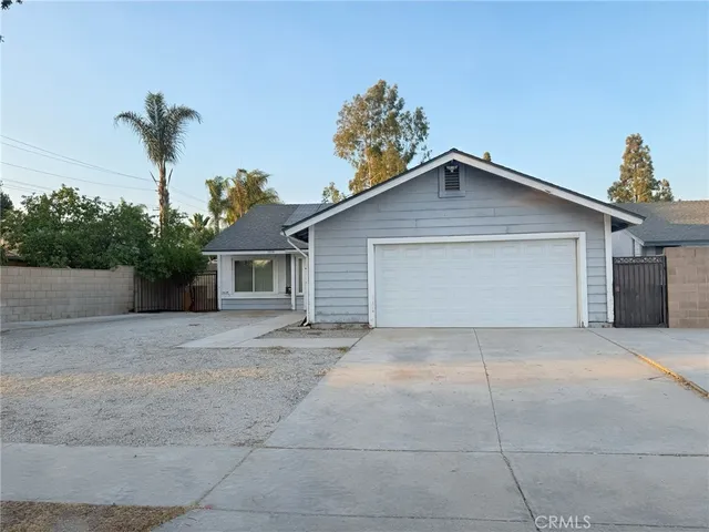 a view of a house with a yard and a garage