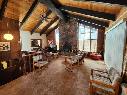 a living room with furniture a air conditioner vent and a window