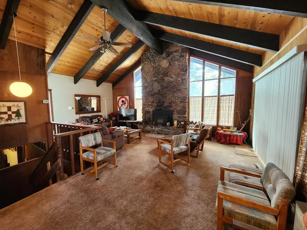 a living room with furniture a air conditioner vent and a window