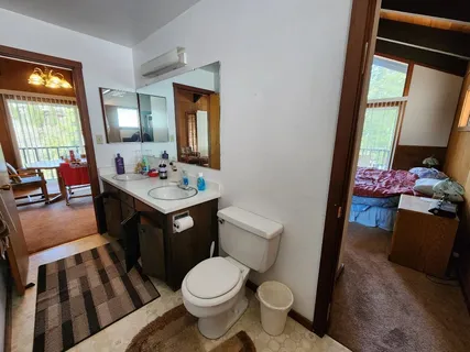 a bathroom with a sink vanity granite and toilet