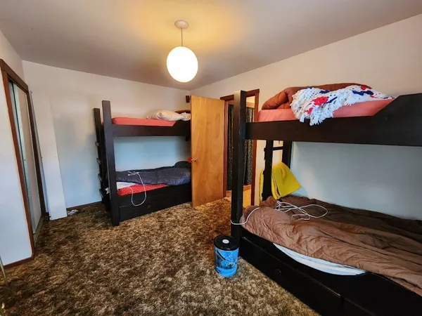 a bedroom with bed and a window