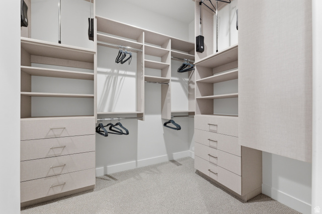 2559 West Aurora Avenue Mapleton, UT 84664 - Photo 21 of 60 Custom closet system featuring multiple hanging rods, integrated shelving, and built-in drawers with modern hardware