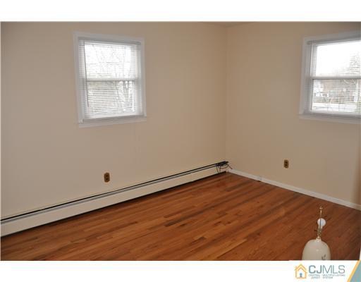 30 Warwick Road Edison, NJ 08820 - Photo 11 of 16 a view of an empty room with wooden floor and a window