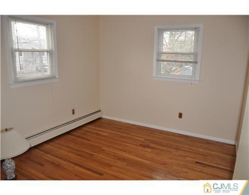 30 Warwick Road Edison, NJ 08820 - Photo 12 of 16 a view of an empty room with wooden floor and a window