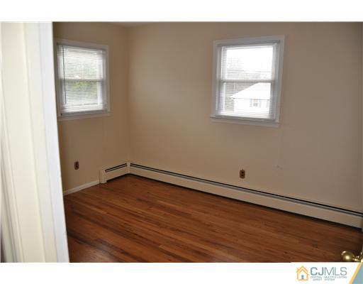 30 Warwick Road Edison, NJ 08820 - Photo 13 of 16 a view of an empty room with wooden floor and a window