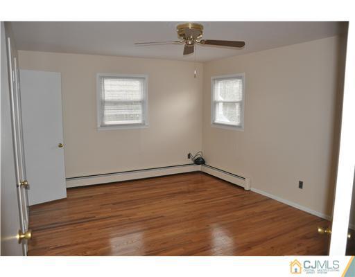 30 Warwick Road Edison, NJ 08820 - Photo 14 of 16 a view of an empty room with wooden floor and a window