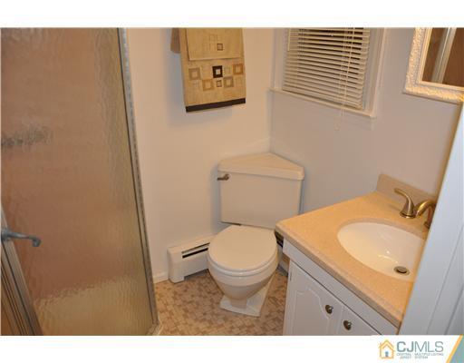 30 Warwick Road Edison, NJ 08820 - Photo 16 of 16 a bathroom with a granite countertop toilet and a sink