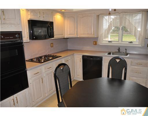 30 Warwick Road Edison, NJ 08820 - Photo 6 of 16 a kitchen with a stove a sink and a microwave