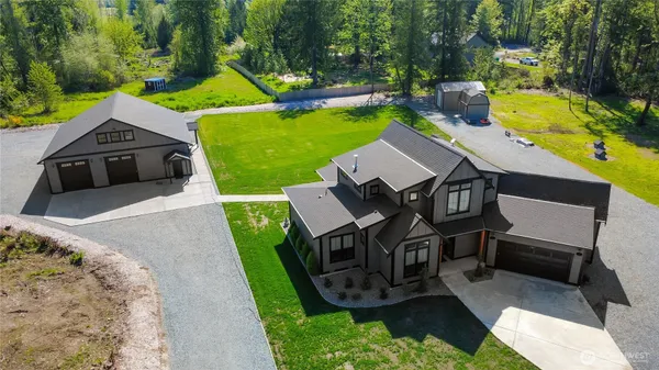 an aerial view of a house with swimming pool garden and patio