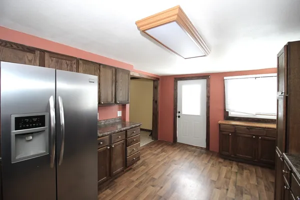 a kitchen with stainless steel appliances granite countertop a refrigerator and a sink