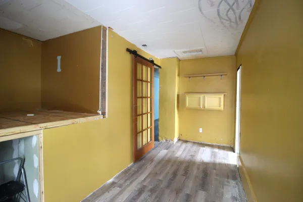 a view of a hallway with wooden floor