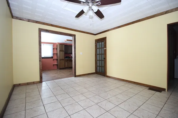 a view of a livingroom with a chandelier furniture and windows