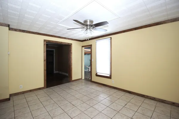 a view of a livingroom with a ceiling fan and window