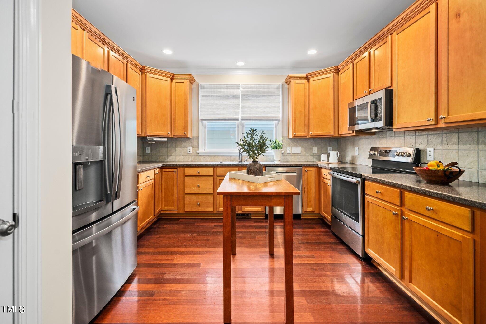 222 Homegate Circle Apex, NC 27502 - Photo 12 of 33 a kitchen with stainless steel appliances a sink window and cabinets