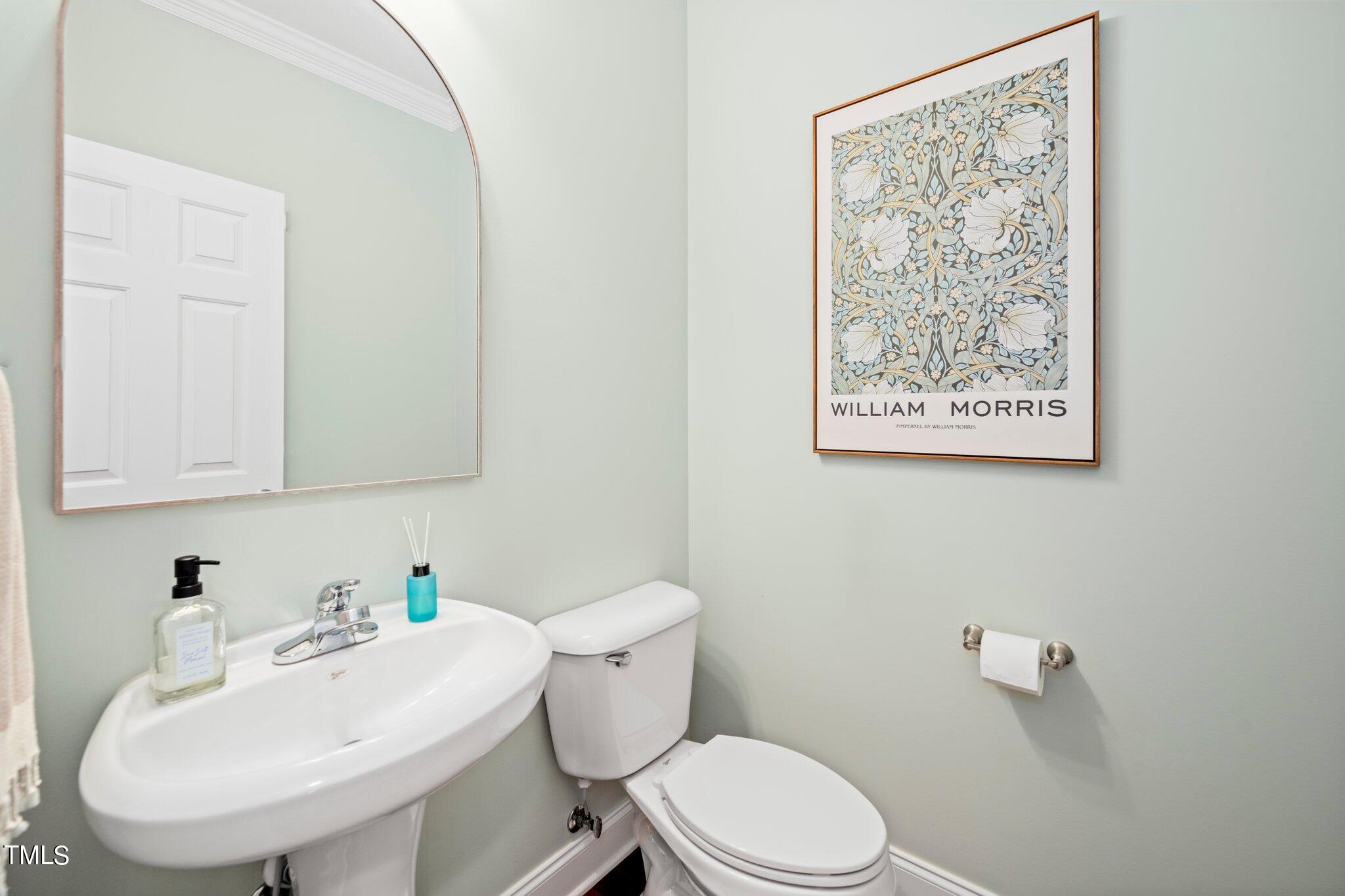 222 Homegate Circle Apex, NC 27502 - Photo 14 of 33 a white toilet sitting next to a bathroom sink