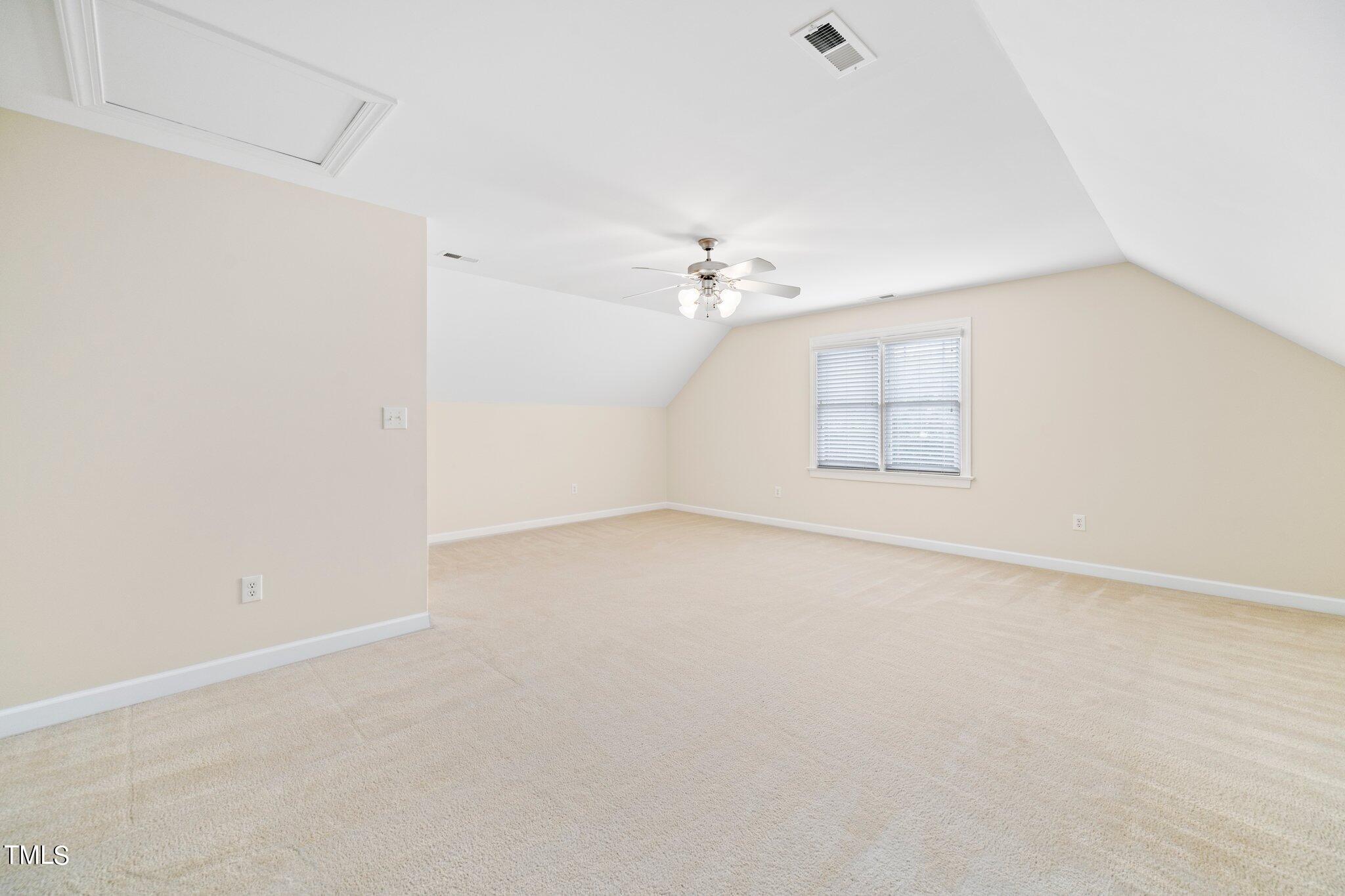 222 Homegate Circle Apex, NC 27502 - Photo 19 of 33 an empty room with windows and chandelier fan