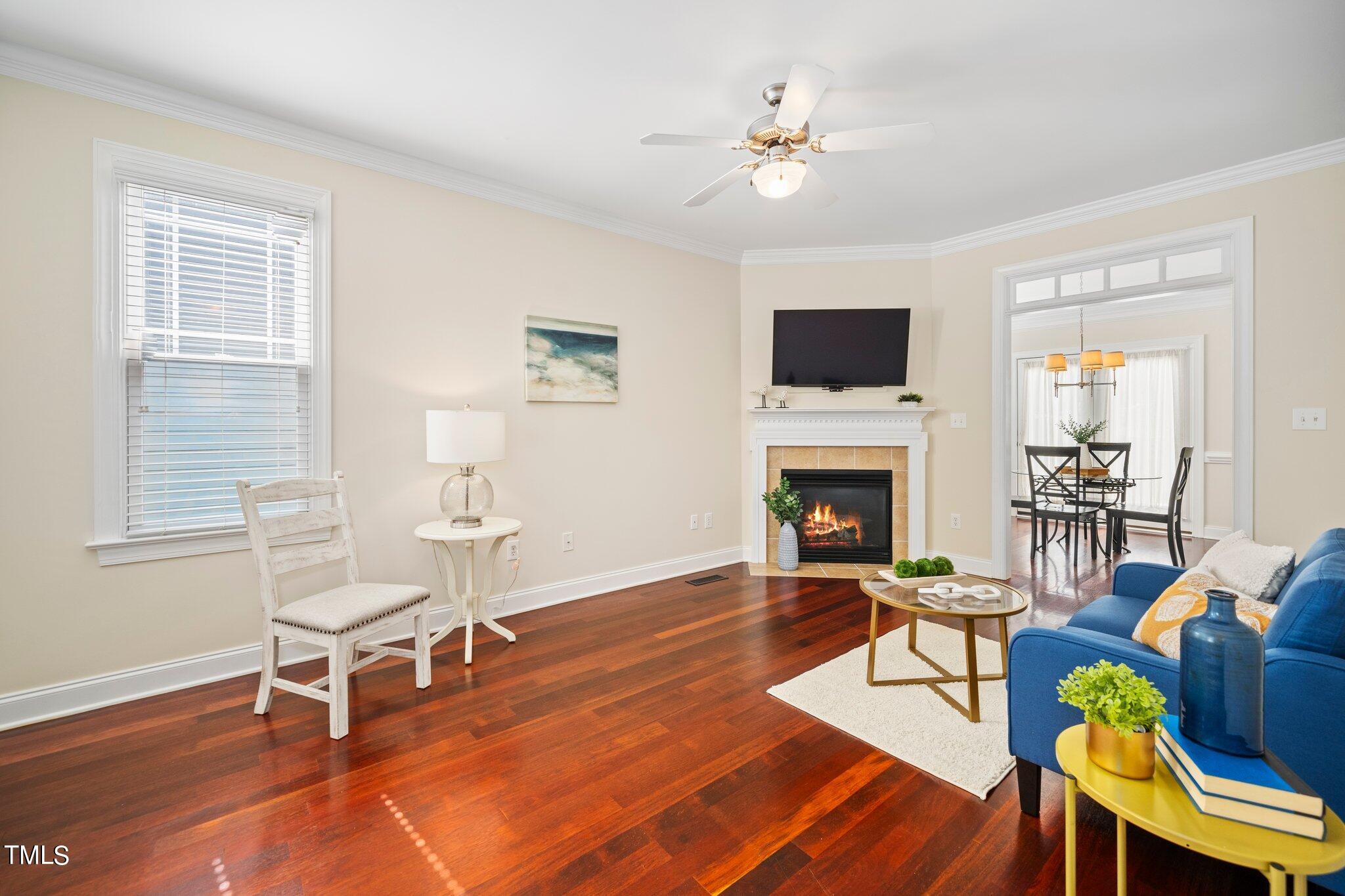 222 Homegate Circle Apex, NC 27502 - Photo 8 of 33 a living room with furniture a flat screen tv and a fireplace