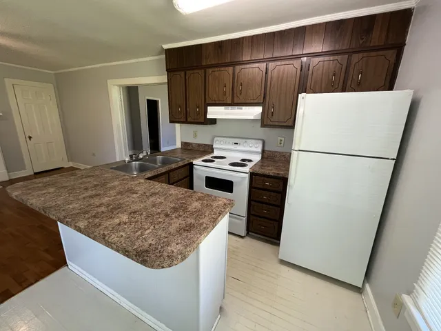a kitchen with a refrigerator and a stove