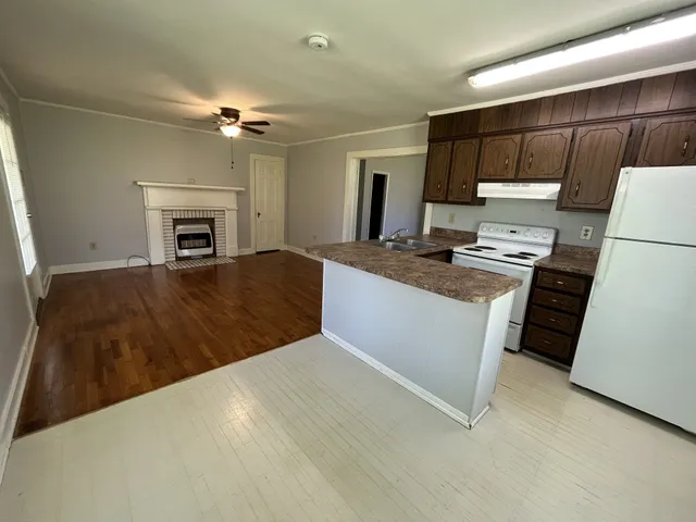 a kitchen with kitchen island a stove a sink and a refrigerator
