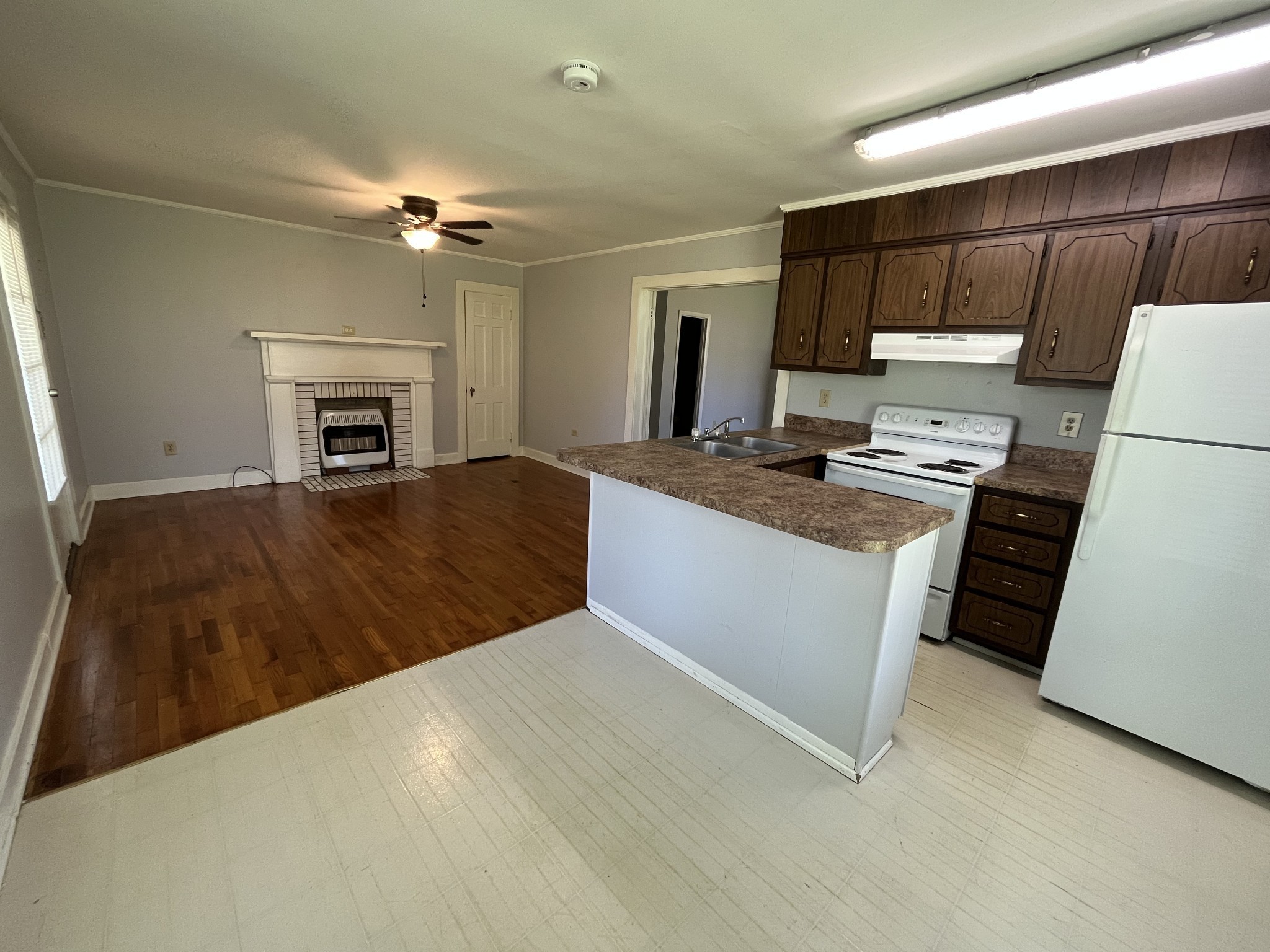 437 East Jefferson Street Pulaski, TN 38478 - Photo 6 of 11 a kitchen with kitchen island a stove a sink and a refrigerator