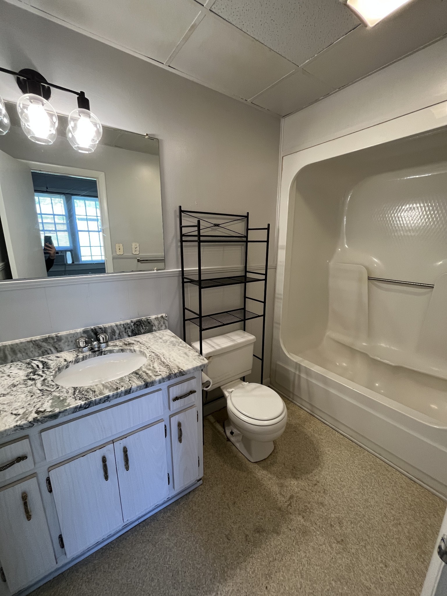 437 East Jefferson Street Pulaski, TN 38478 - Photo 9 of 11 a bathroom with a granite countertop toilet sink and mirror