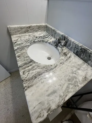 a bathroom with a sink and a mirror