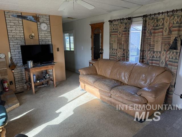 140 Brownlee Loop Road Horseshoe Bend, ID 83629 - Photo 20 of 29 Carpeted living area featuring a decorative brick accent wall