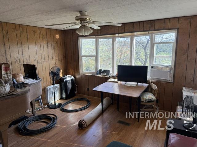140 Brownlee Loop Road Horseshoe Bend, ID 83629 - Photo 23 of 29 Room featuring paneled walls, wood-finish flooring, a multi-panel window, and an overhead ceiling fan