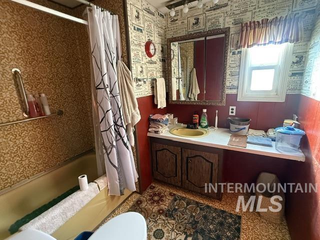 140 Brownlee Loop Road Horseshoe Bend, ID 83629 - Photo 27 of 29 Bathroom featuring a vanity with a yellow basin, an integrated countertop, and wood-finish cabinetry