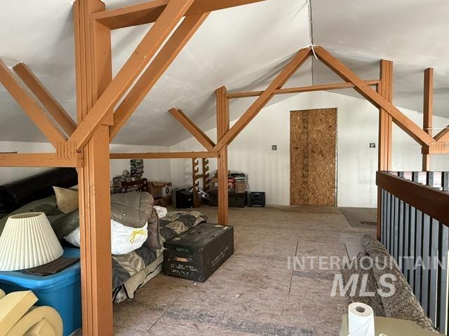 140 Brownlee Loop Road Horseshoe Bend, ID 83629 - Photo 9 of 29 Spacious attic room featuring exposed wood beam construction, a vaulted ceiling, and unfinished flooring