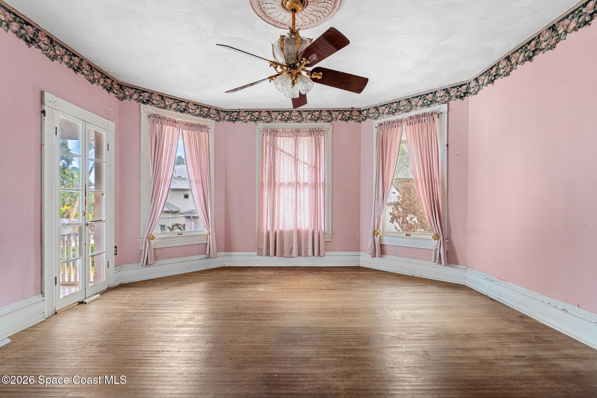 1101 Rockledge Drive Rockledge, FL 32955 - Photo 29 of 76 an empty room with wooden floor fan and windows