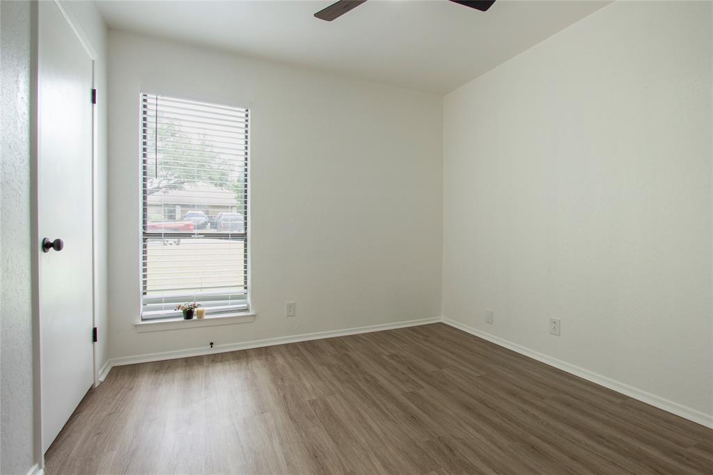 1205 Augusta Road Benbrook, TX 76126 - Photo 16 of 21 Room with wood-finish flooring, a single window with blinds, and a dark-toned ceiling fan