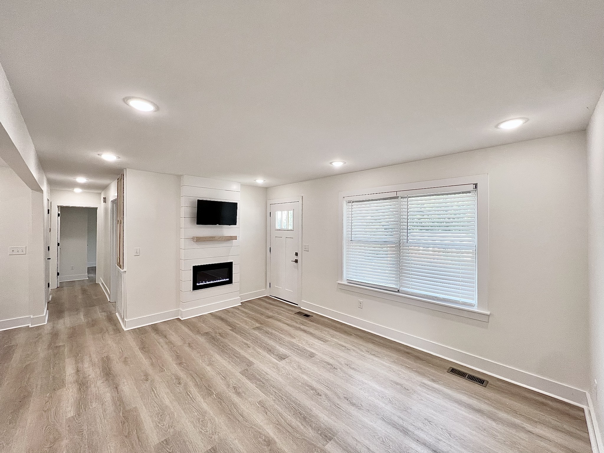207 North Cedar Lane Pulaski, TN 38478 - Photo 2 of 66 an empty room with windows and fireplace