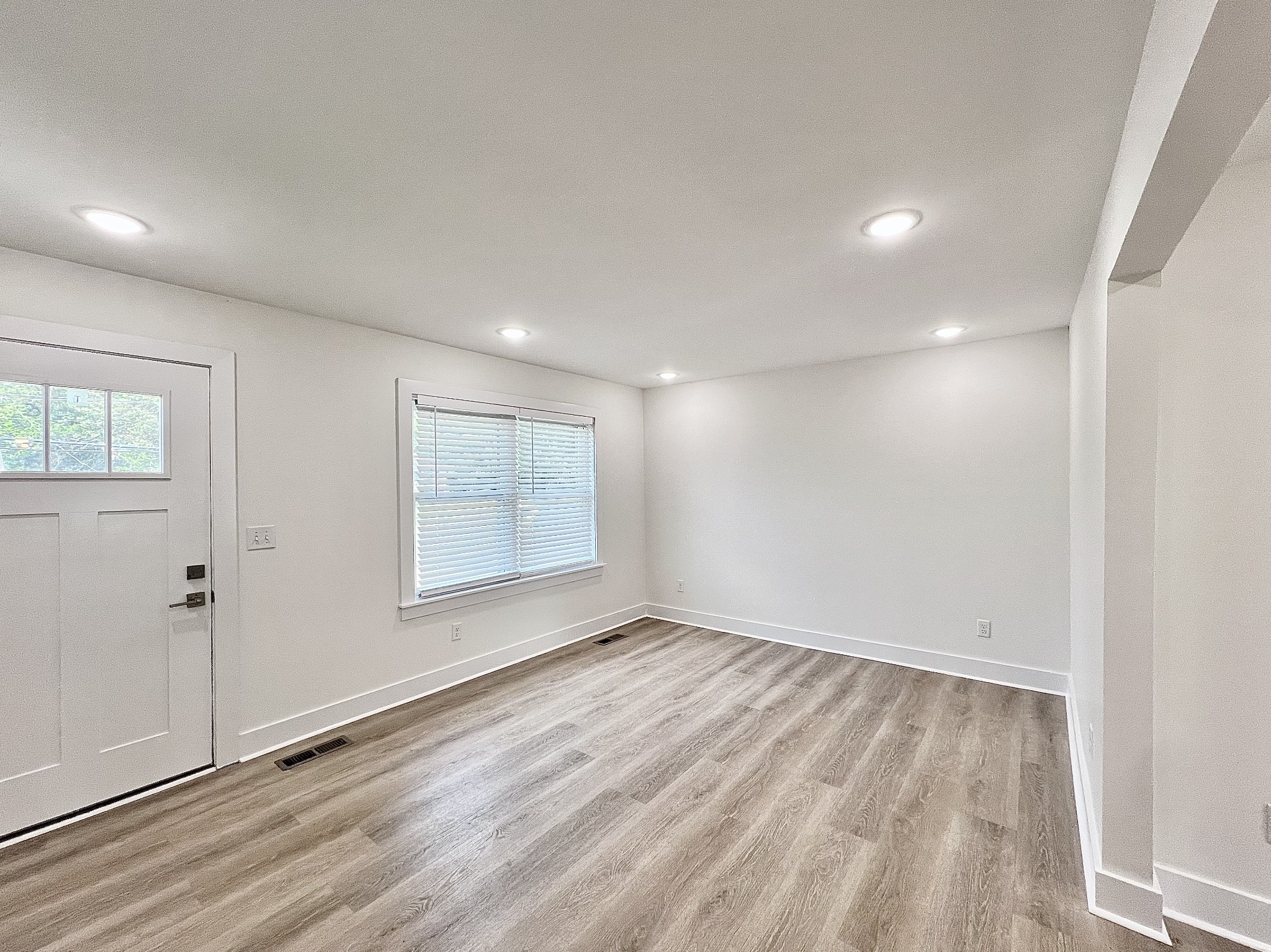 207 North Cedar Lane Pulaski, TN 38478 - Photo 3 of 66 an empty room with wooden floor and windows