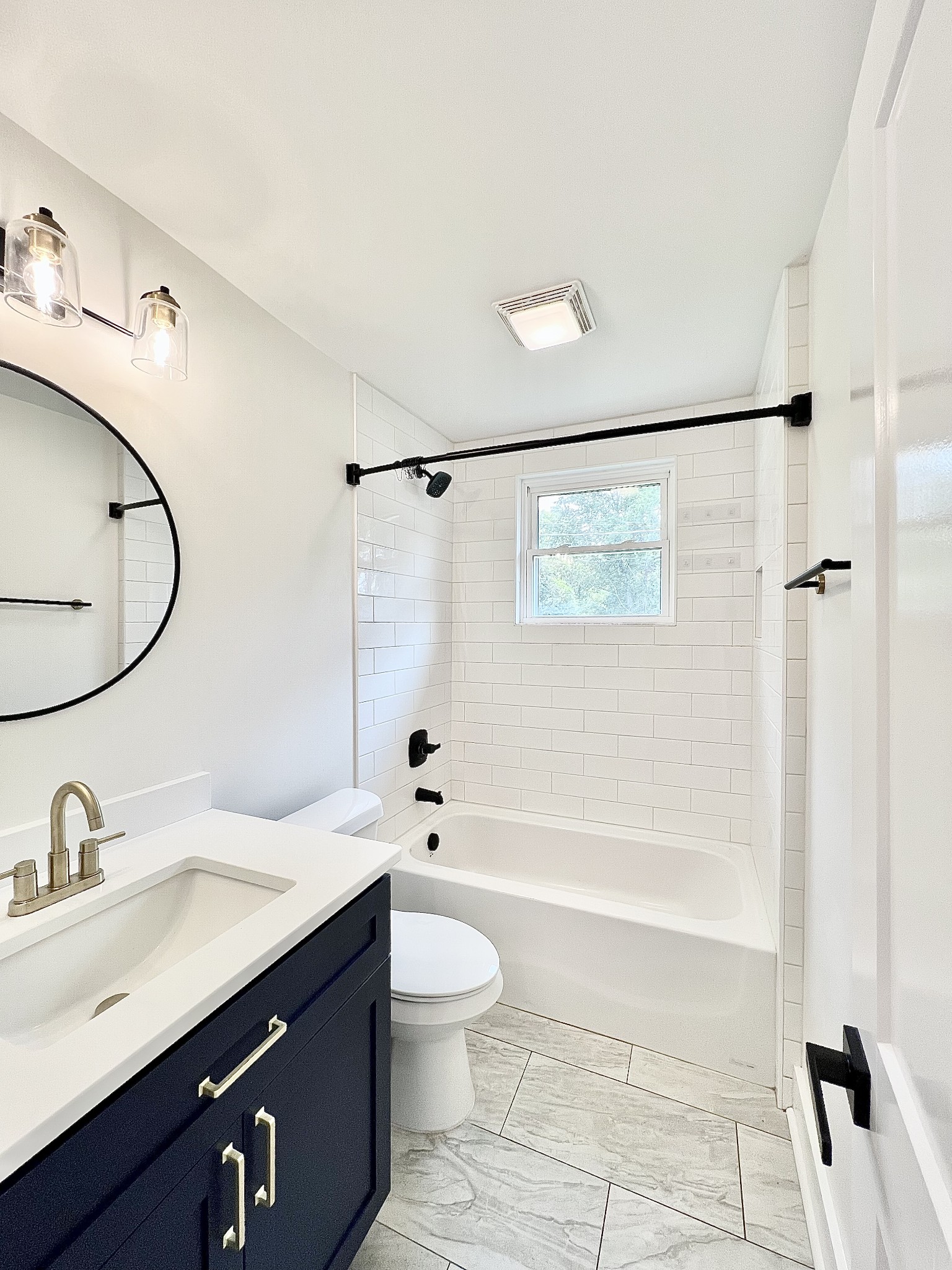 207 North Cedar Lane Pulaski, TN 38478 - Photo 35 of 66 a bathroom with a granite countertop sink a toilet a mirror a bathtub and shower