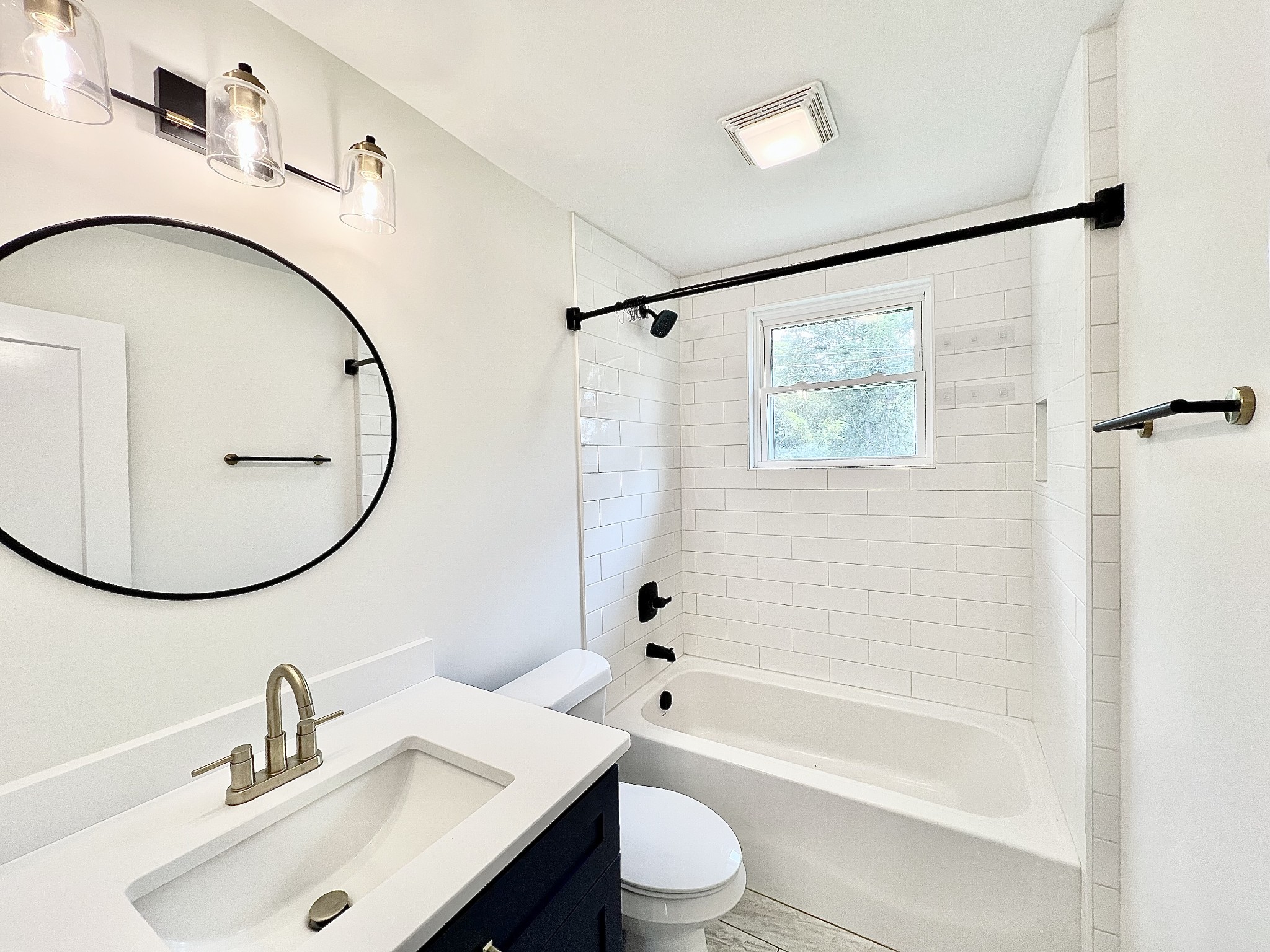 207 North Cedar Lane Pulaski, TN 38478 - Photo 38 of 66 a bathroom with a sink a mirror a toilet and a bathtub