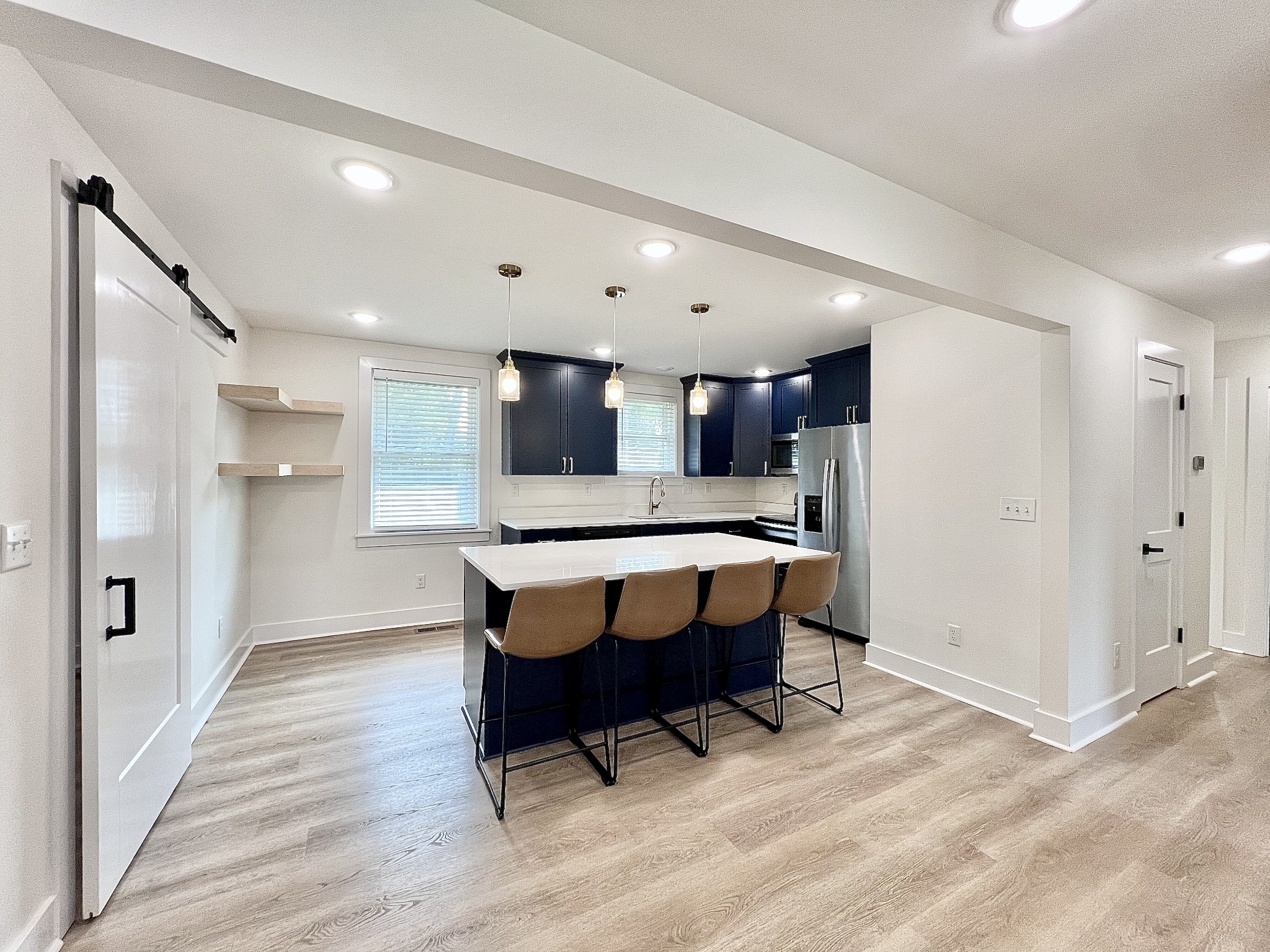 207 North Cedar Lane Pulaski, TN 38478 - Photo 8 of 66 a kitchen with a table chairs refrigerator and microwave