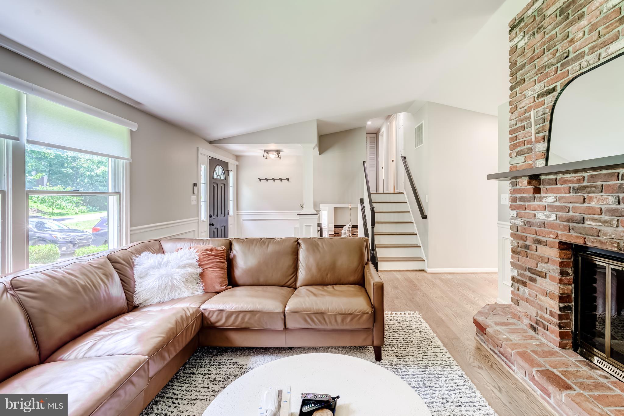 11926 Appling Valley Road Fairfax, VA 22030 - Photo 36 of 60 a living room with furniture a fireplace and a large window