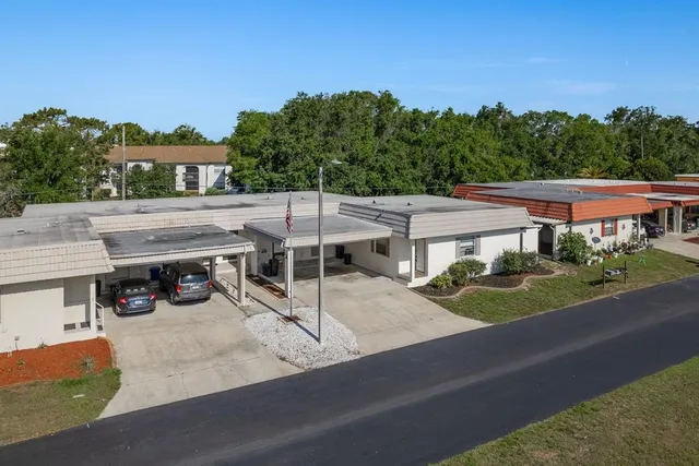 an aerial view of a house with garden space and street view