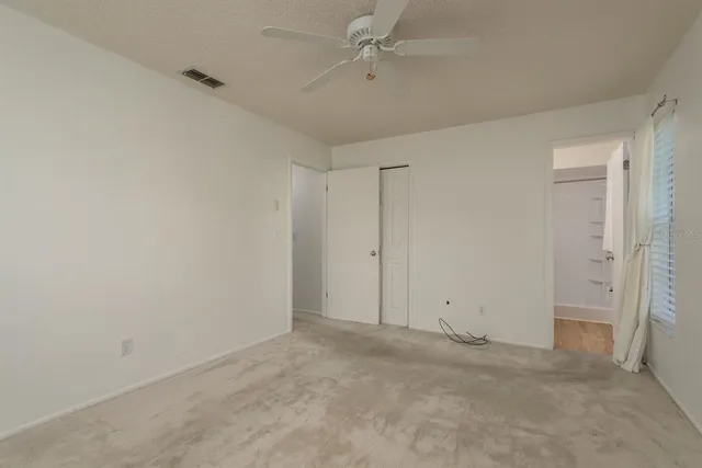 a bathroom with a granite countertop sink a toilet and shower
