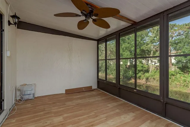 a view of a door and chair in back of house