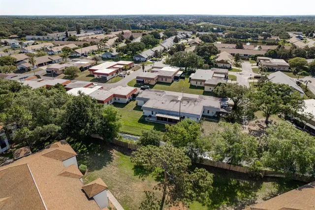 an aerial view of residential houses with outdoor space and river
