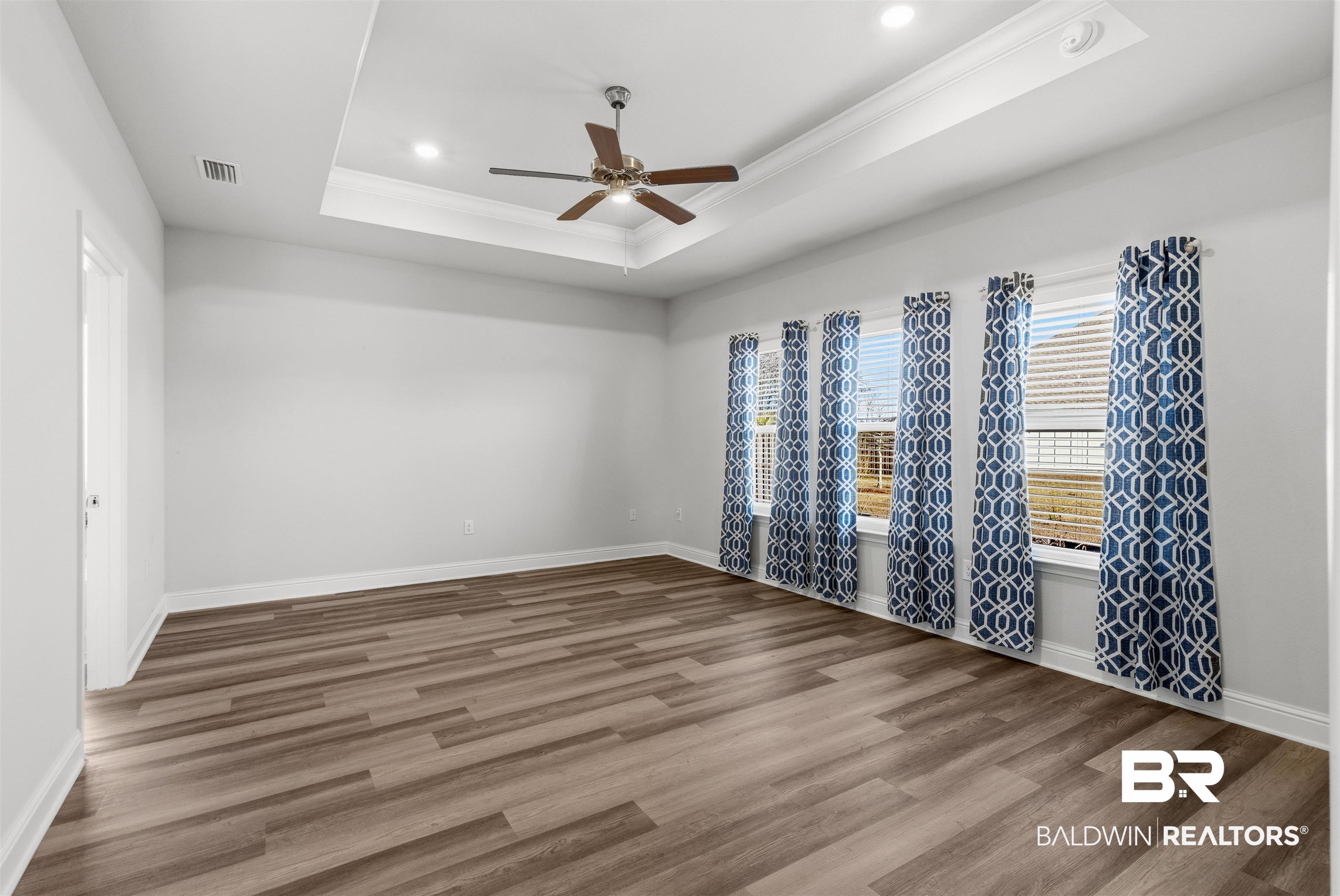 485 Shepard Street Gulf Shores, AL 36542 - Photo 19 of 53 Primary bedroom featuring crown molding, light wood-style floors, and ceiling fan