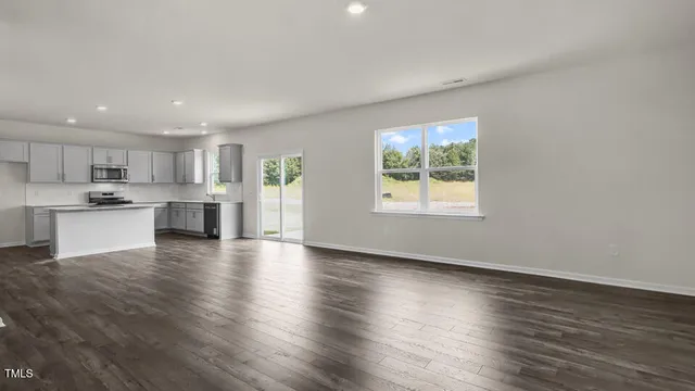 a view of kitchen with wooden floor and windows