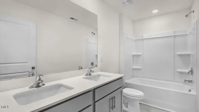 a bathroom with a sink toilet a tub and shower