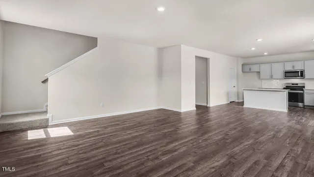 a view of a kitchen with a sink and a refrigerator