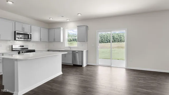 a kitchen with a sink a window and cabinets