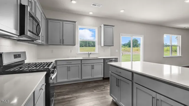 a kitchen that has a sink and a stove in it