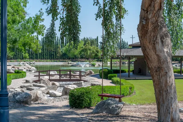 a view of a patio with a table and chairs under an umbrella