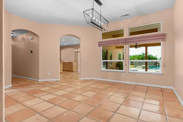 a kitchen with stainless steel appliances granite countertop a refrigerator a sink dishwasher and white cabinets with wooden floor